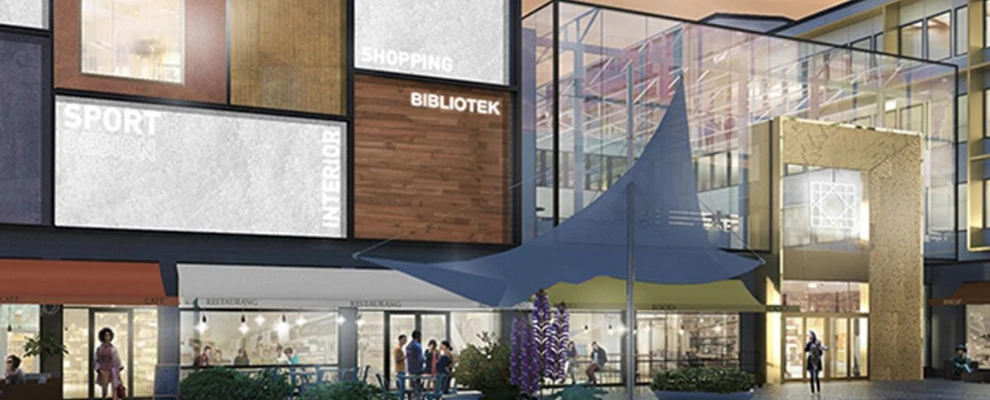Exteriör av ett köpcentrum med skyltar för shopping, bibliotek och fitness.
